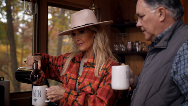 a couple pouring coffee in a cabin